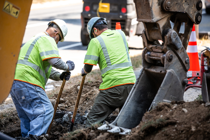 two men digging in the ground